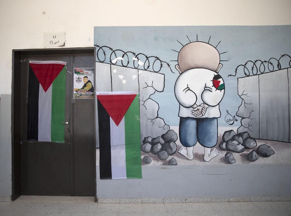 A poster of 17-year-old Palestinian Mohammad Hamayel adorns a door of a classroom, in the village of Beita, south of the West Bank city of Nablus. Monday, June 14, 2021. Hamayel was killed during clashes with Israeli forces following a protest against the wildcat Jewish settlement of Eviatar that was established last month without the permission of Israeli authorities on land the Palestinians say is privately owned. (AP Photo)